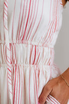 Close-up of a white dress with red stripes and a blurred background