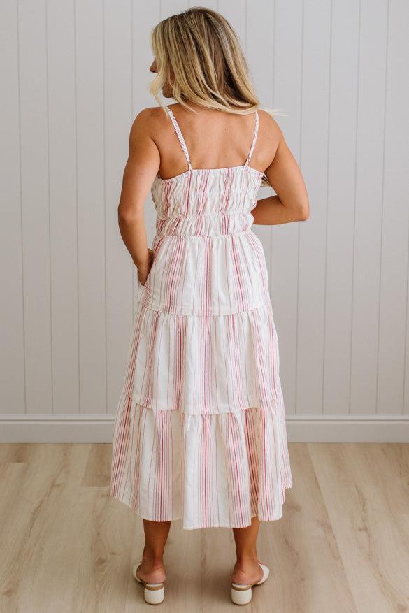 Woman wearing a striped dress with a neutral background