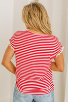 Person wearing a red and white striped shirt with lace trim sleeves against a plain background