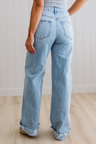 Light blue jeans worn by a person on a plain background