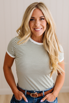 Woman wearing a striped shirt with a neutral background