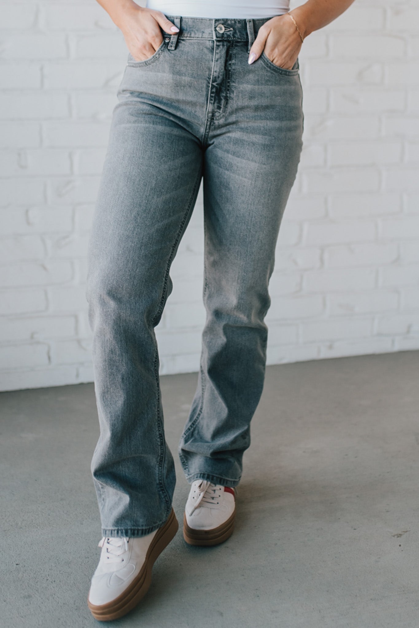 Super high rise dad jeans in grey wash with fading, whiskers, five-pocket design, belt loops, and hidden zip fly with button closure.