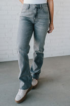 Super high rise dad jeans in grey wash with fading, whiskers, five-pocket design, belt loops, and hidden zip fly with button closure.