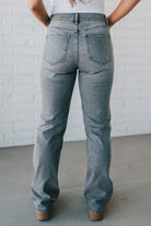 Super high rise dad jeans in grey wash with fading, whiskers, five-pocket design, belt loops, and hidden zip fly with button closure.