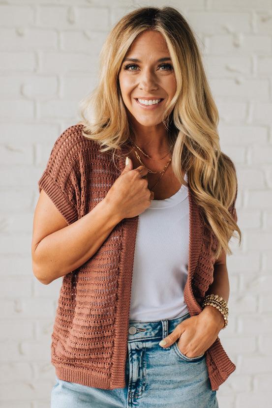 BLONDE WOMAN WEARING A CROCHET KNIT CAP SLEEVE OPEN CARDIGAN.