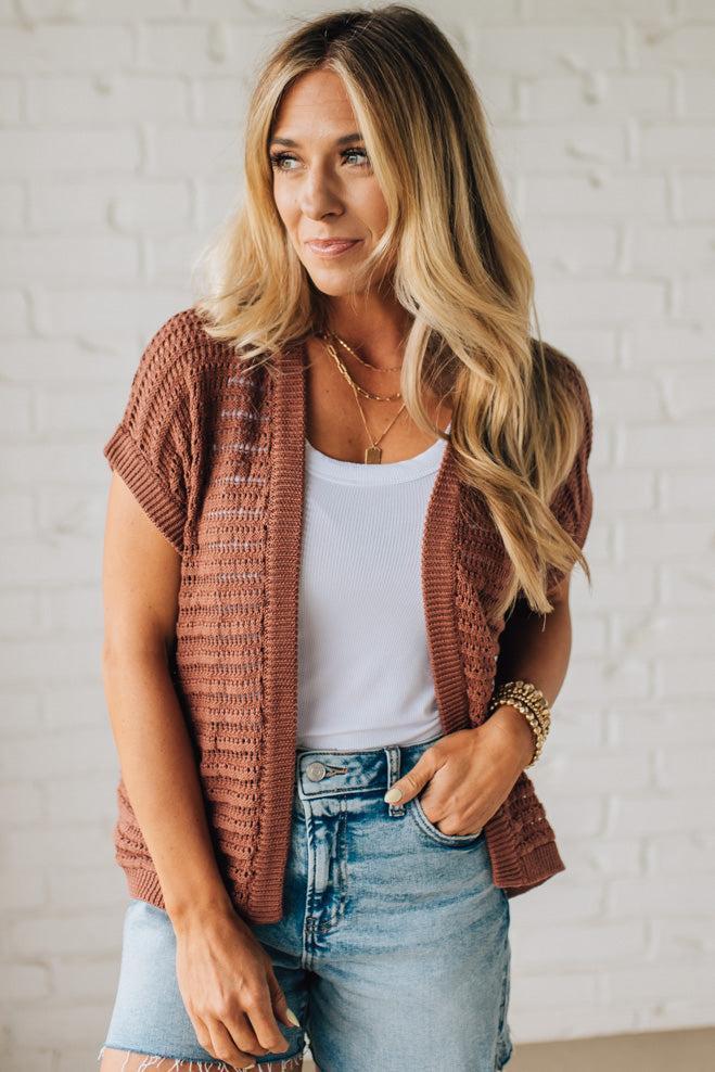 BLONDE WOMAN WEARING A CROCHET KNIT CAP SLEEVE OPEN CARDIGAN.