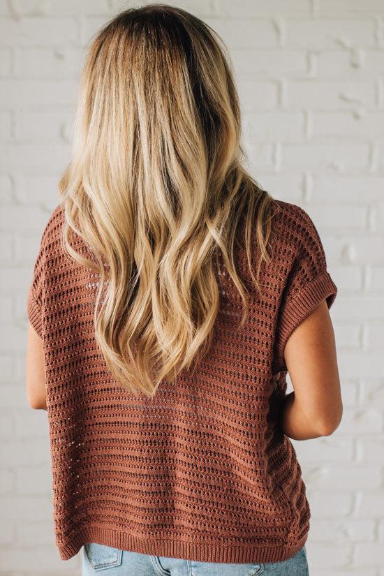 BLONDE WOMAN WEARING A CROCHET KNIT CAP SLEEVE OPEN CARDIGAN.