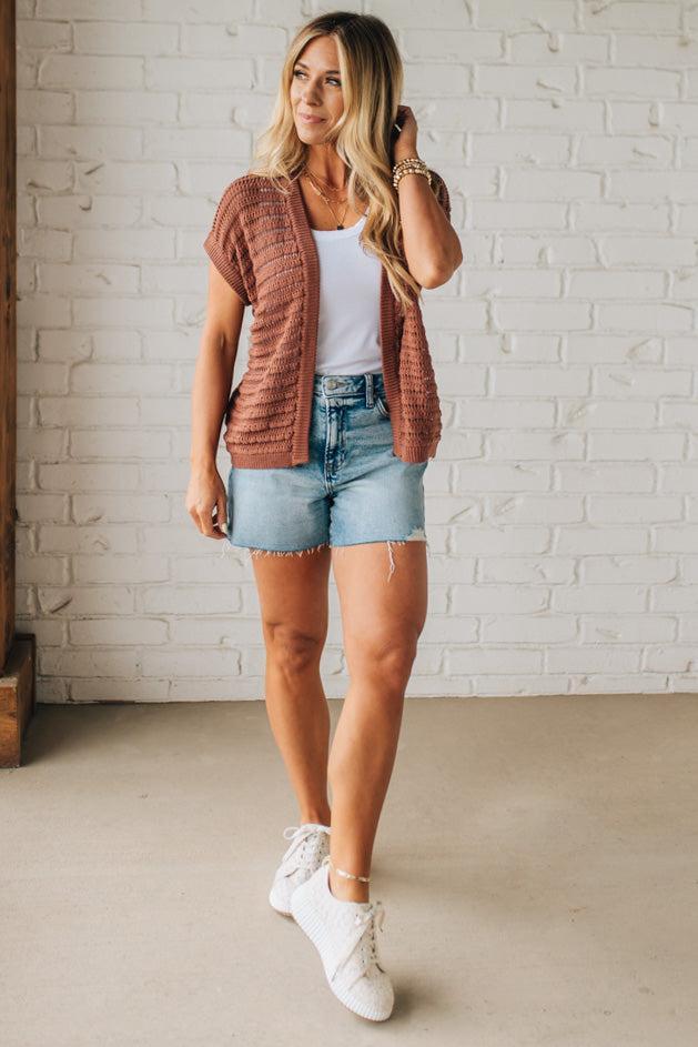 BLONDE WOMAN WEARING A CROCHET KNIT CAP SLEEVE OPEN CARDIGAN.