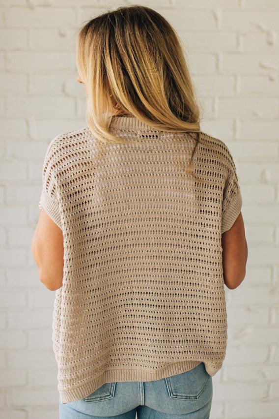 BLONDE WOMAN WEARING A CROCHET KNIT CAP SLEEVE OPEN CARDIGAN.