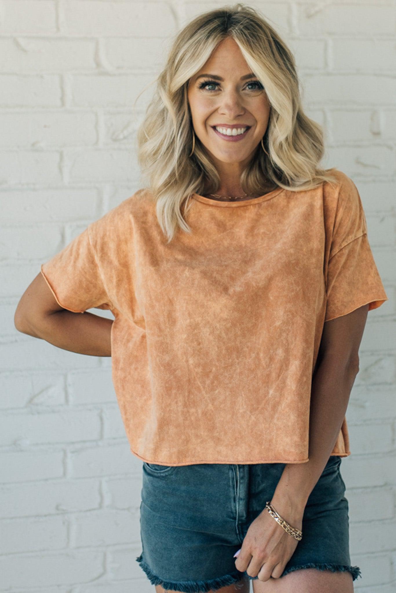 women wearing a burnt orange mineral wash short sleeve boxy fit tee shirt