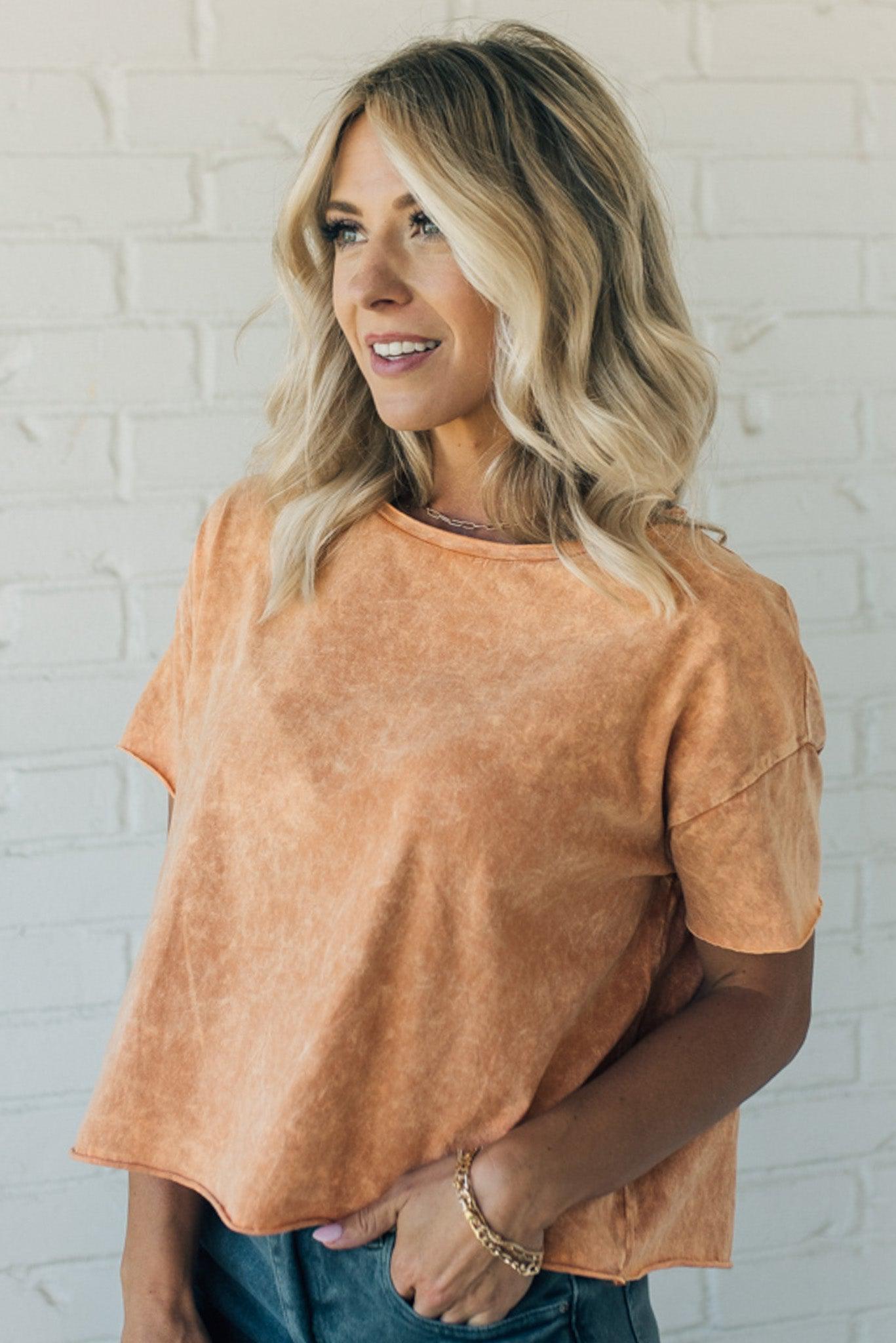 women wearing a burnt orange mineral wash short sleeve boxy fit tee shirt