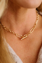 Gold chain necklace on a person's neck