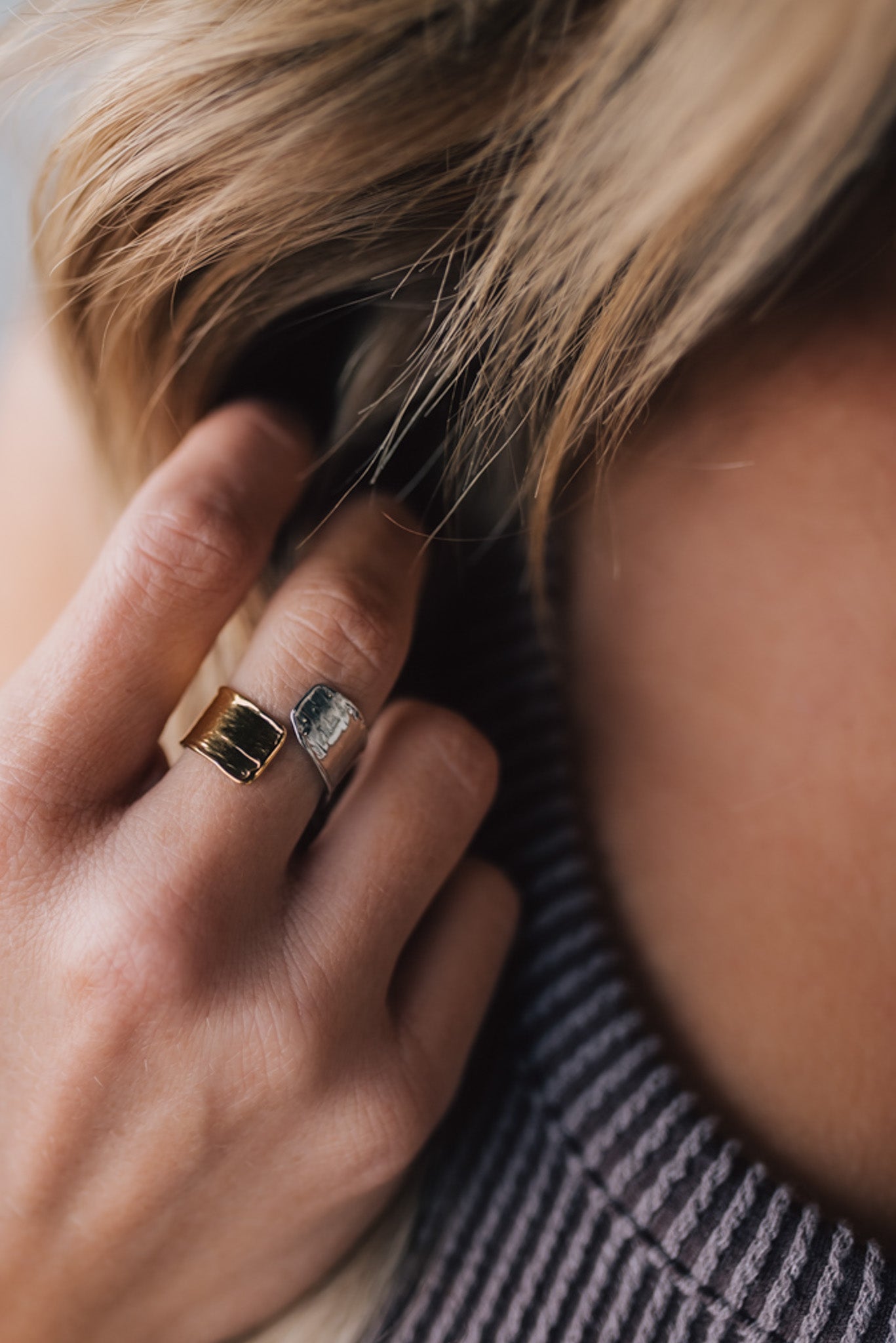 woman modeling a two toned silver and gold wrap style ring.