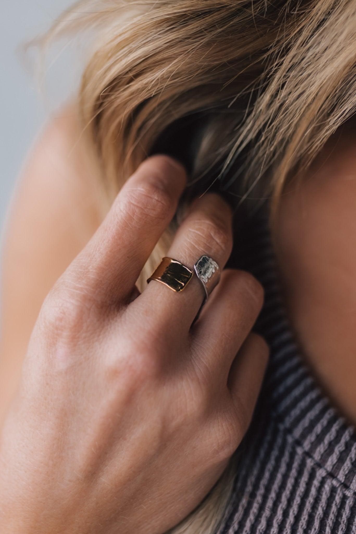 woman modeling a two toned silver and gold wrap style ring.