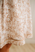 Close-up of a floral dress with a neutral background
