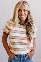 Woman wearing a striped shirt with a plain background