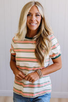 Woman wearing a striped shirt with a neutral background