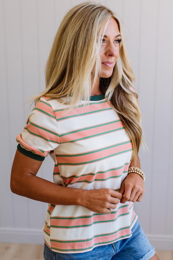 Woman wearing a striped shirt with a neutral background