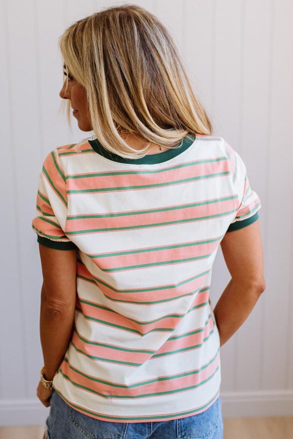 Woman wearing a striped shirt with a neutral background