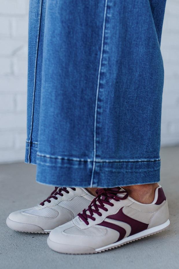 Beige sneakers with wine colored stripes and laces