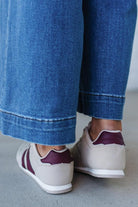 Beige sneakers with wine colored stripes and laces