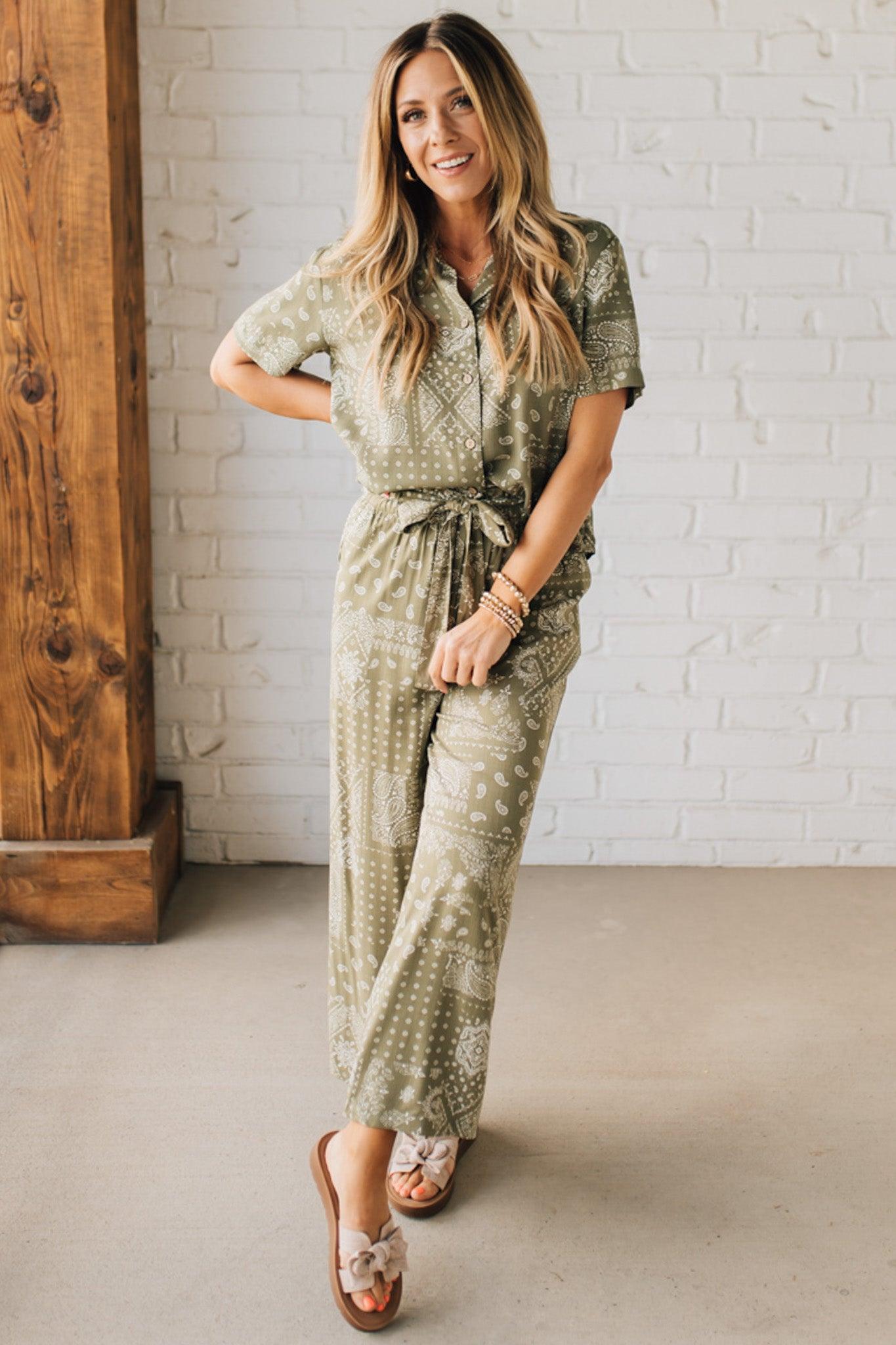 Blonde Woman in Tan Slides Wearing Paisley Print Belted Paper Bag Crop Pants.