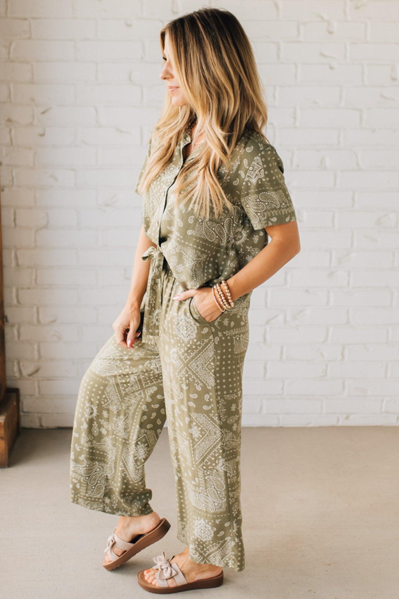 Blonde Woman in Tan Slides Wearing Paisley Print Belted Paper Bag Crop Pants.
