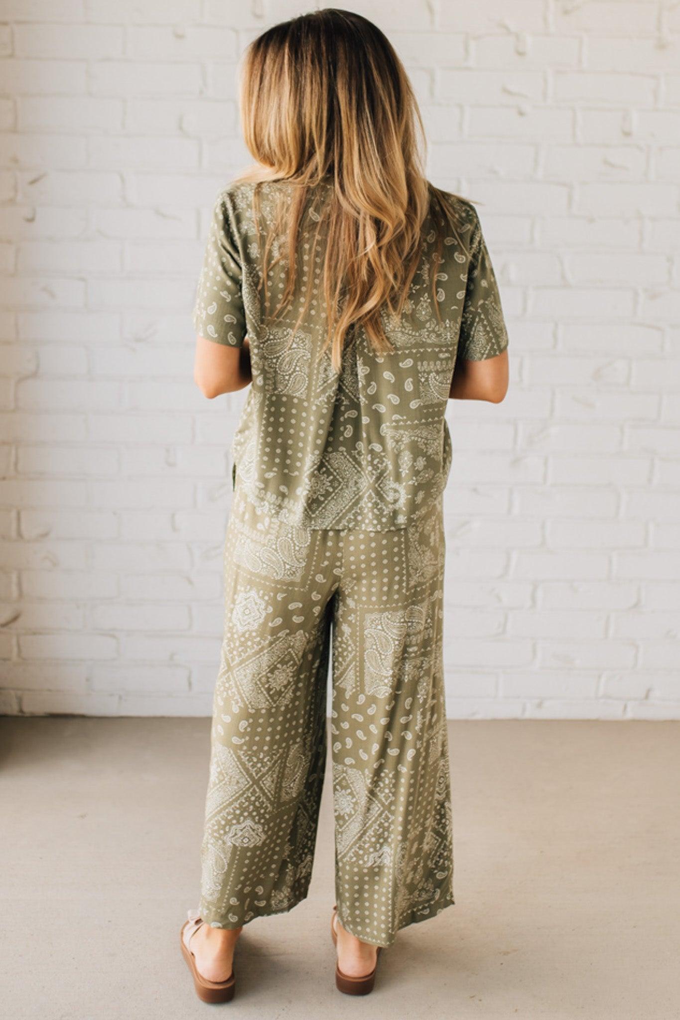 Blonde Woman Wearing a Loose Fit Paisley Print Button Front Top with Center Back Pleat and Lay Flat Collar.