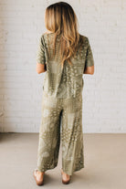 Blonde Woman Wearing a Loose Fit Paisley Print Button Front Top with Center Back Pleat and Lay Flat Collar.