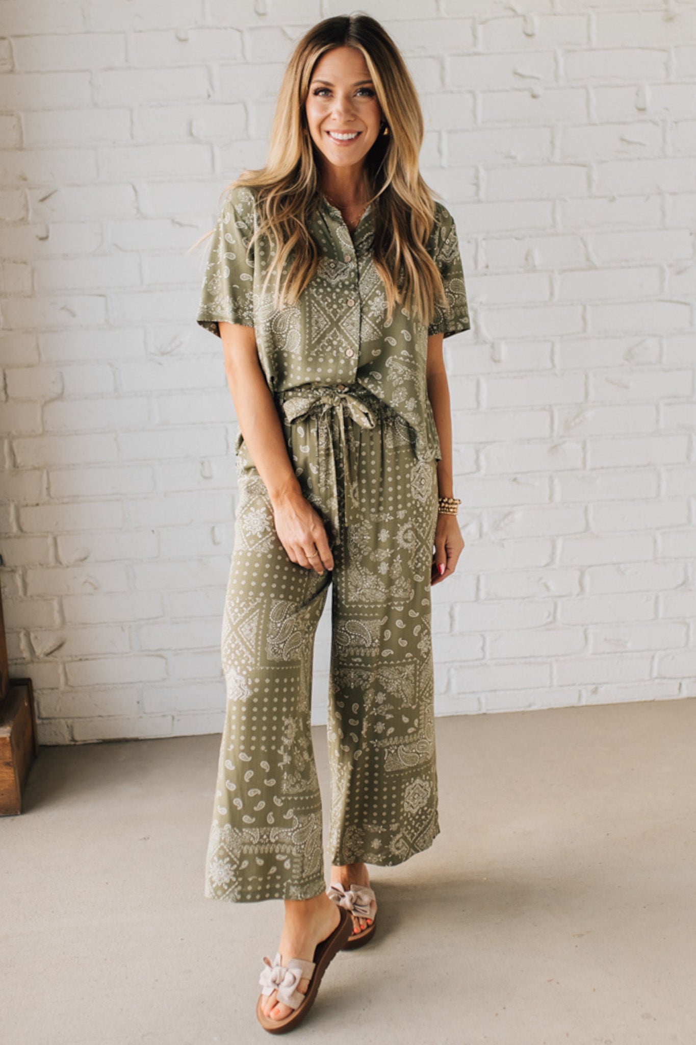 Blonde Woman Wearing a Loose Fit Paisley Print Button Front Top with Center Back Pleat and Lay Flat Collar.