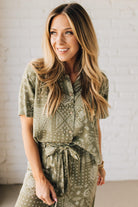 Blonde Woman Wearing a Loose Fit Paisley Print Button Front Top with Center Back Pleat and Lay Flat Collar.