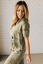 Blonde Woman Wearing a Loose Fit Paisley Print Button Front Top with Center Back Pleat and Lay Flat Collar.