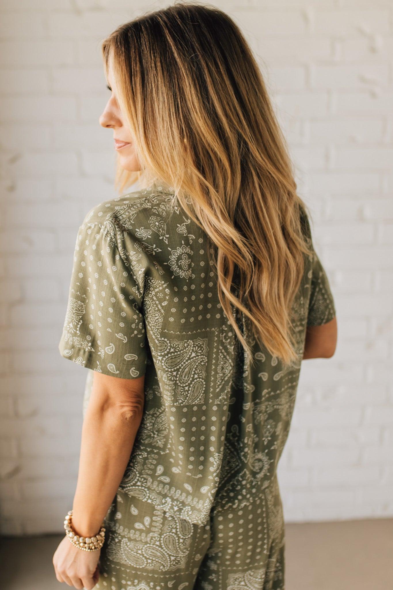 Blonde Woman Wearing a Loose Fit Paisley Print Button Front Top with Center Back Pleat and Lay Flat Collar.