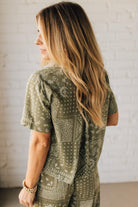 Blonde Woman Wearing a Loose Fit Paisley Print Button Front Top with Center Back Pleat and Lay Flat Collar.
