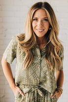 Blonde Woman Wearing a Loose Fit Paisley Print Button Front Top with Center Back Pleat and Lay Flat Collar.
