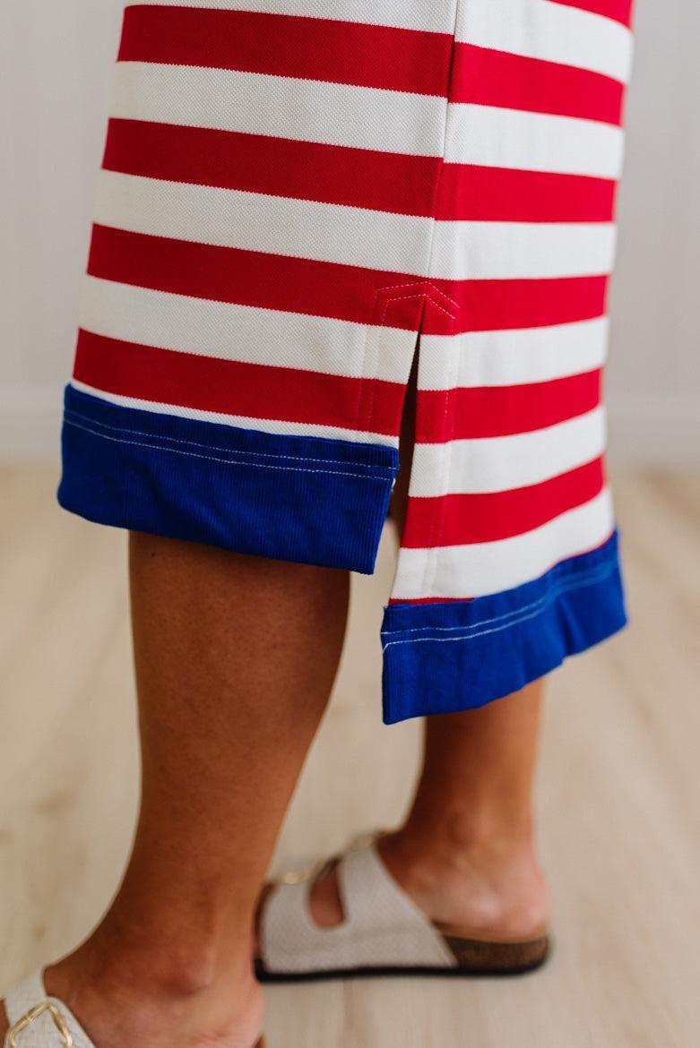 Red, white, and blue striped dress hem on a blurred background