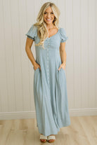 Woman wearing a light blue dress with a white background