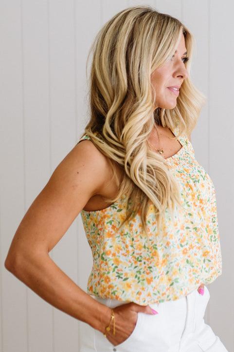 Woman wearing a floral top with a neutral background