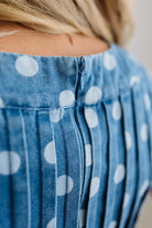 Close-up of a blue polka dot romper with a blurred background