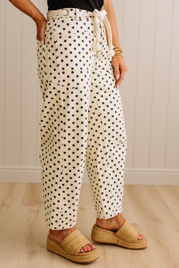 Person wearing polka dot pants with a white background