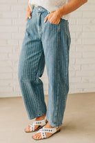Blonde Woman in Sandals wearing Washed Stripe Denim Mid Rise Barrel Pants.