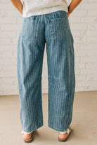 Blonde Woman in Sandals wearing Washed Stripe Denim Mid Rise Barrel Pants.