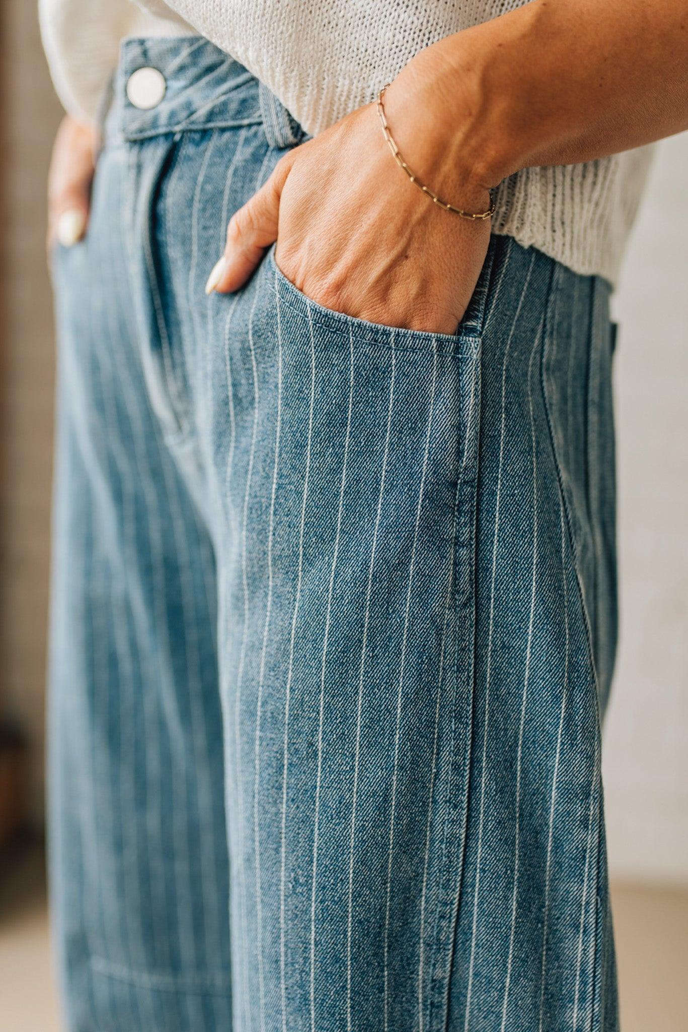 Blonde Woman in Sandals wearing Washed Stripe Denim Mid Rise Barrel Pants.