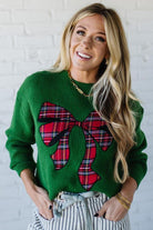 BLONDE WOMAN WEARING CHECKERED PLAID BIG RIBBON CHRISTMAS HOLIDAY LOOSE FIT SWEATER PULL OVER TOP