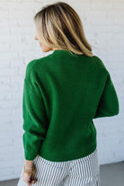 BLONDE WOMAN WEARING CHECKERED PLAID BIG RIBBON CHRISTMAS HOLIDAY LOOSE FIT SWEATER PULL OVER TOP