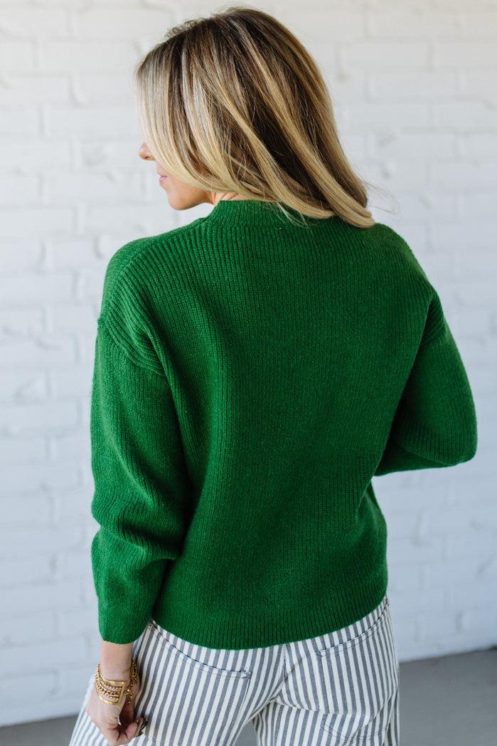 BLONDE WOMAN WEARING CHECKERED PLAID BIG RIBBON CHRISTMAS HOLIDAY LOOSE FIT SWEATER PULL OVER TOP