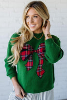 BLONDE WOMAN WEARING CHECKERED PLAID BIG RIBBON CHRISTMAS HOLIDAY LOOSE FIT SWEATER PULL OVER TOP
