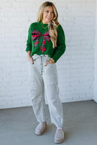 BLONDE WOMAN WEARING CHECKERED PLAID BIG RIBBON CHRISTMAS HOLIDAY LOOSE FIT SWEATER PULL OVER TOP