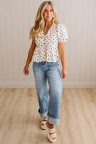 Blonde woman wearing a ivory and black Polka Dot Woven Peter Pan Collar Top with double tie front.