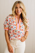 Woman wearing a colorful floral blouse with a white background